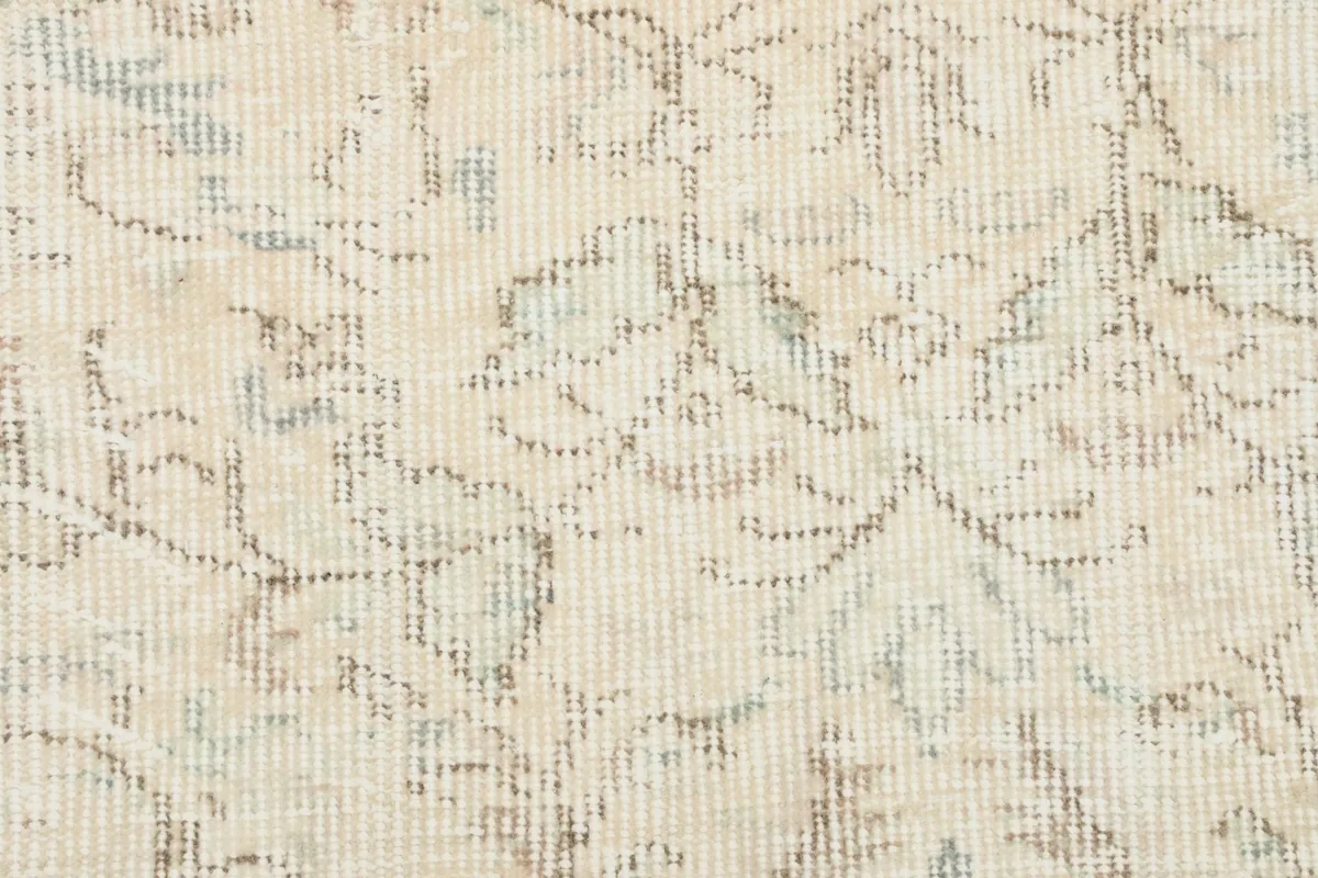 Detailed close-up of the low wool pile, showing the hand-knotted texture and faded colors