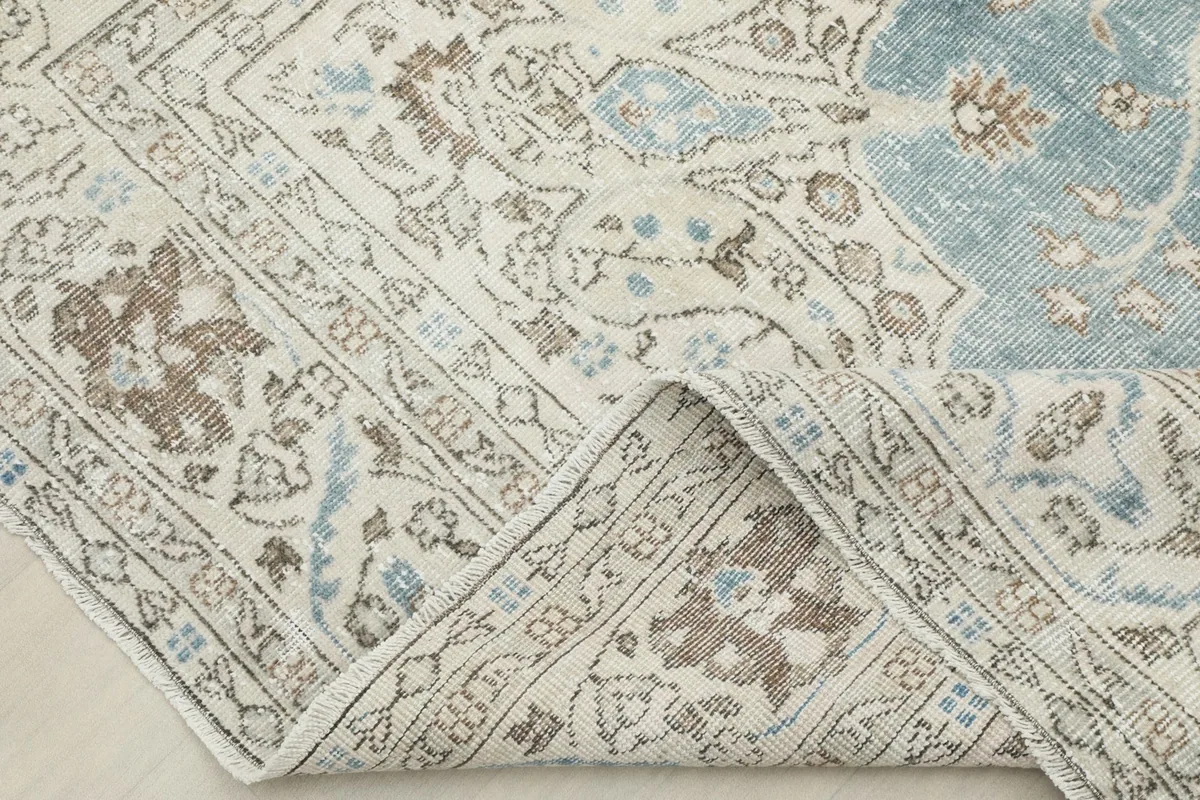 View of the rug's reverse side, revealing the hand-knotted construction and cotton foundation.