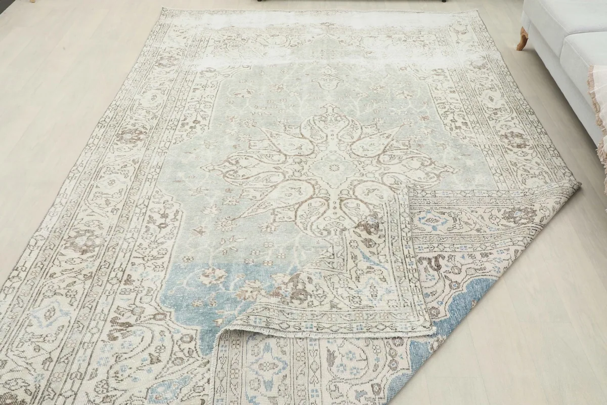 Rug partially folded, demonstrating its flexibility and construction.