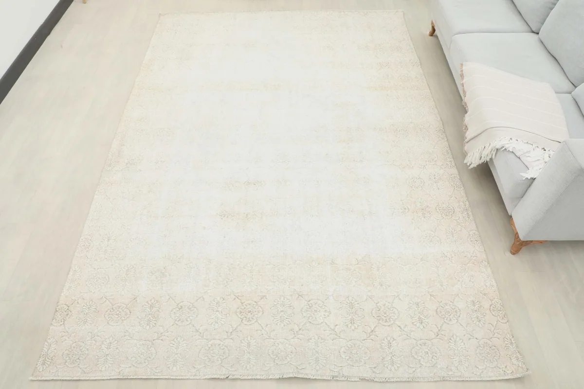 Full room view of the 6'11" x 9'11" cream Anatolian rug grounding the living space