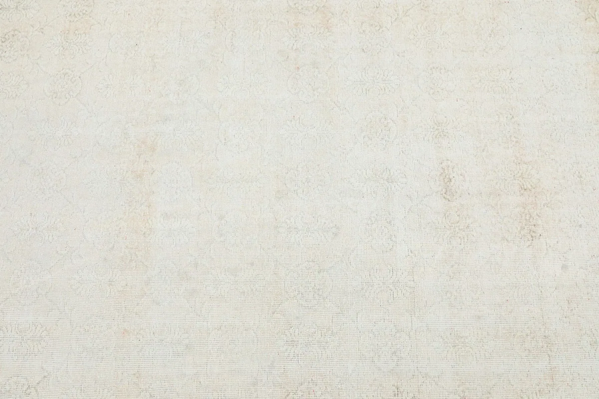 Detailed overhead view of the cream field, showing the subtle, faded motifs and patina