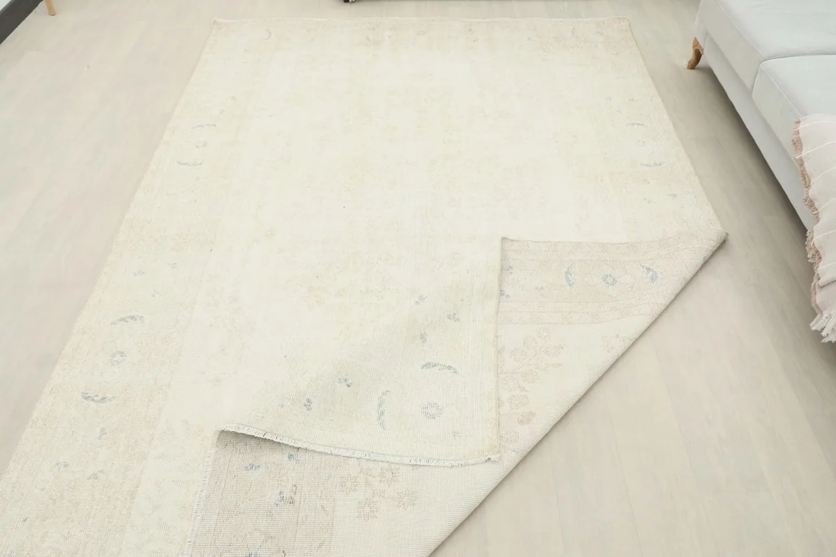 Rug corner folded over, revealing the back construction in a room setting