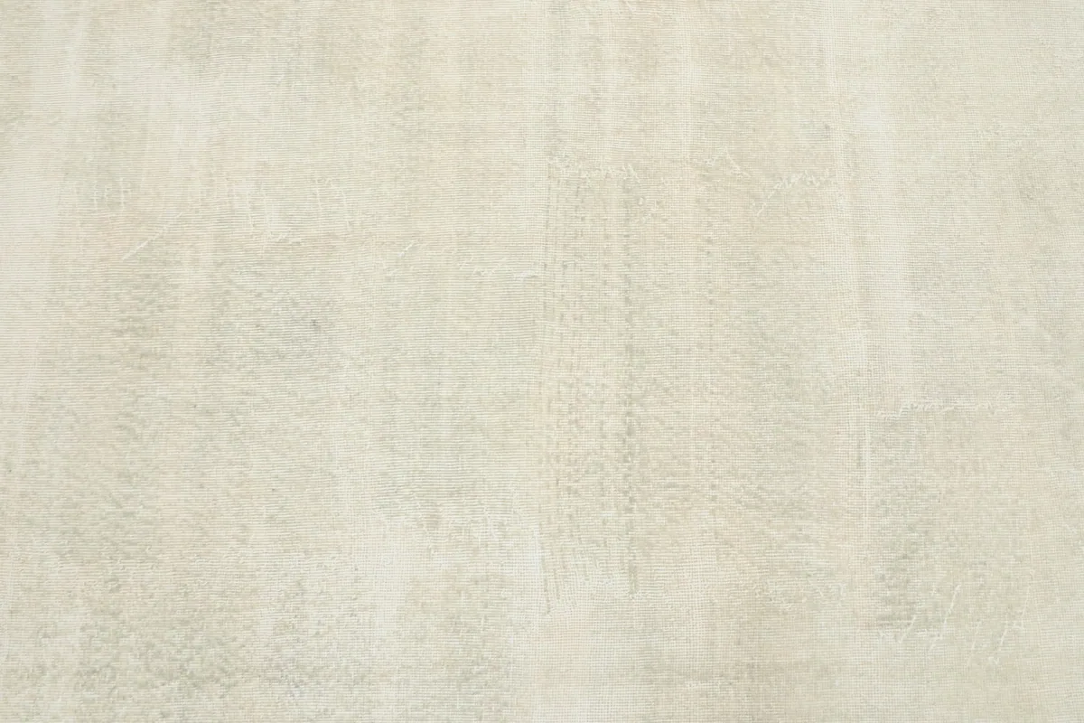 Detailed view of the rug's surface, revealing the subtle geometric motifs and color variations.