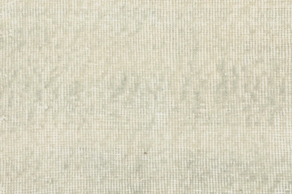 Close-up of the low wool pile texture and the tightly woven surface of the rug.
