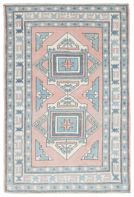 Full top view of the 4x6 rose and blue geometric vintage Anatolian rug on a white background.