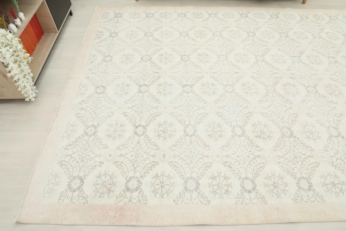 Another angle view of the rug in a room, capturing its texture and the gentle wear.
