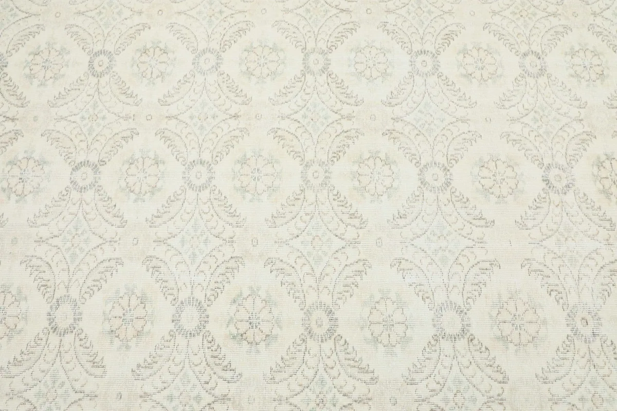 Detailed view of the rug's surface, showing the intricate hand-knotted floral and geometric pattern work.