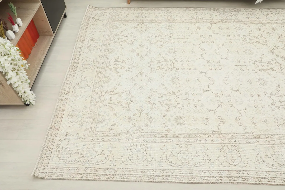 Another angled perspective of the ivory rug, showcasing its full pattern from a different side