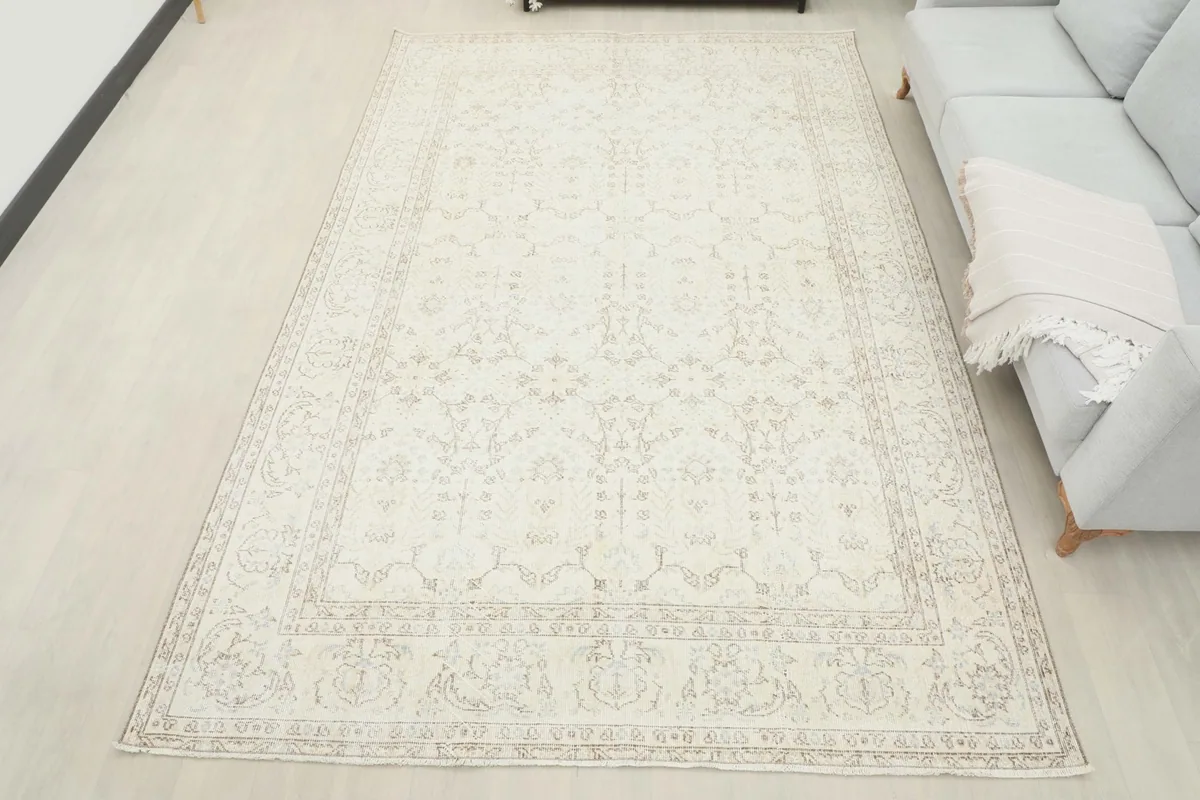 Full view of the ivory Anatolian rug in a living space, demonstrating its large size and placement