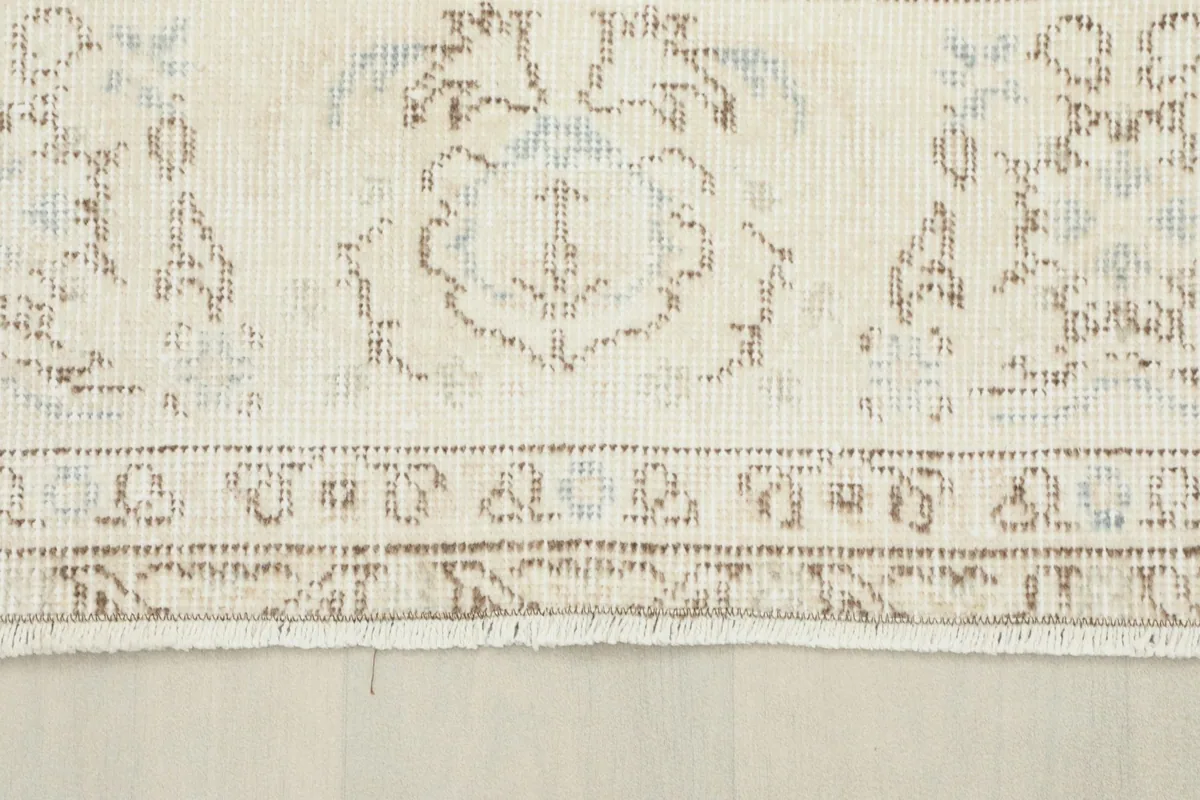 Detailed view of the rug's border, showing the distinct patterns and the low wool pile