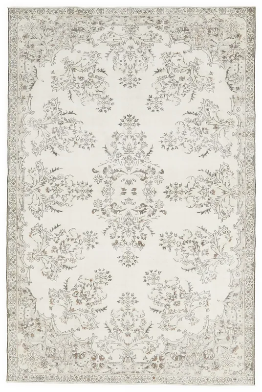 Full overhead view of an ivory and gray floral vintage Anatolian area rug