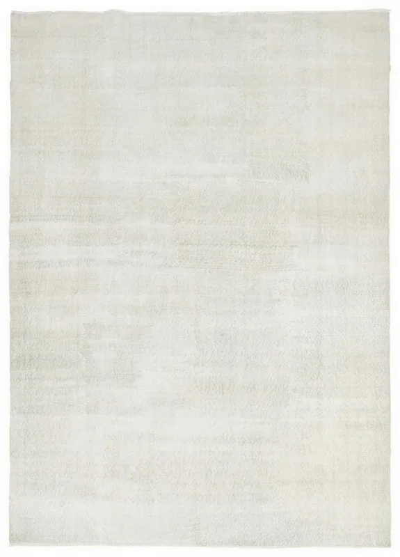 Full overhead view of the ivory floral geometric vintage Anatolian rug on a white background.
