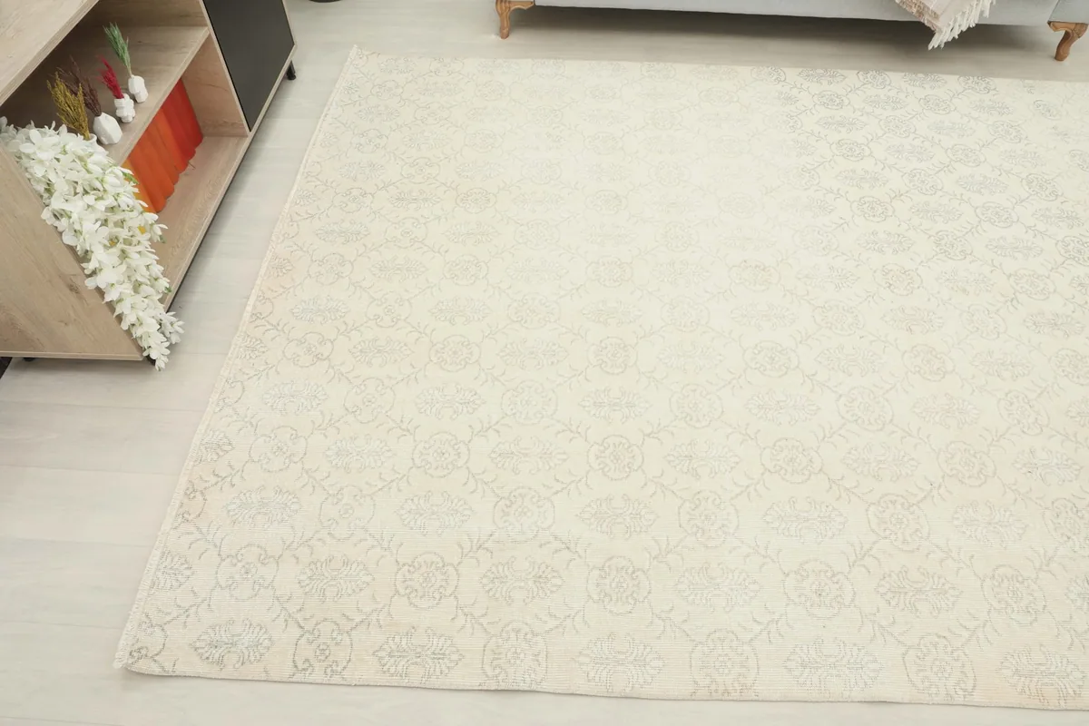 Corner view of the ivory rug in a room, highlighting the soft texture and pattern details.