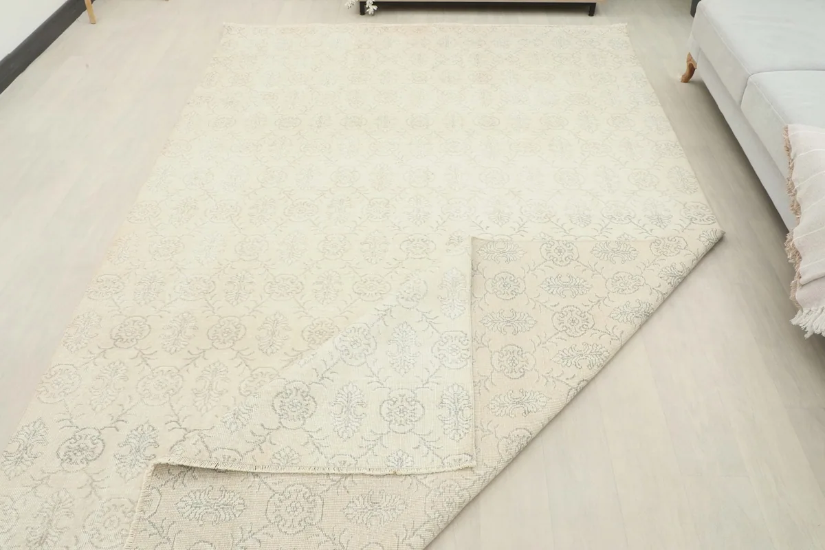 Partial view of the rug's back, revealing the hand-knotted construction and cotton foundation.