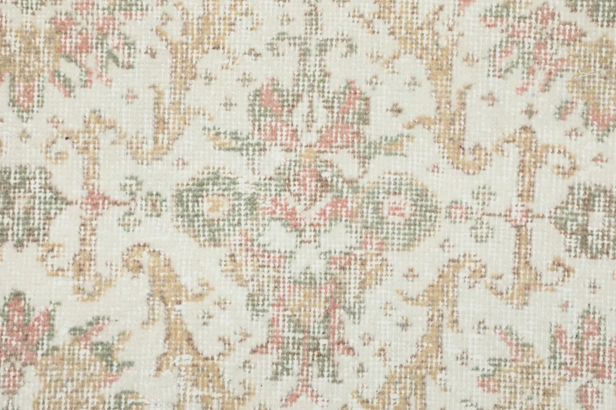 Close-up of the hand-knotted wool pile and the intricate floral pattern