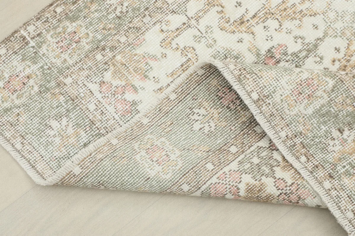 Underside view of the rug, revealing the cotton foundation and hand-knotted construction