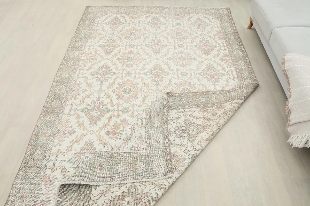 Rug partially folded to show the thickness and flexibility of the vintage wool