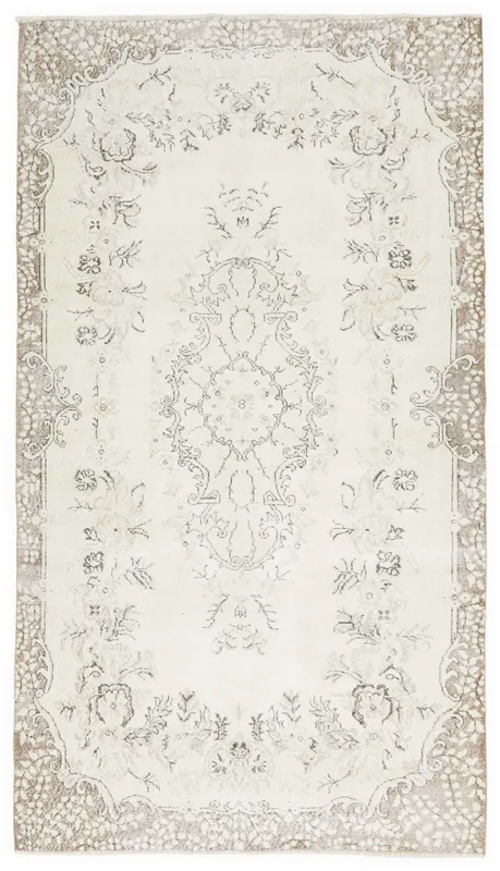 Full top view of the cream and beige vintage Anatolian area rug with medallion and floral patterns