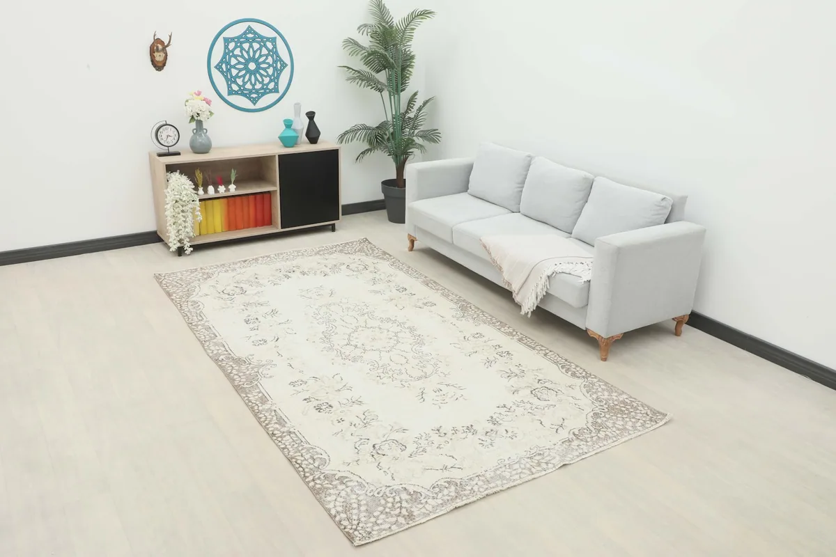 Vintage cream and beige rug styled in a modern living room setting with a light gray sofa