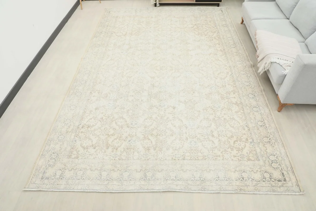 Overhead view of the ivory and beige rug filling a large living area, complementing the decor.