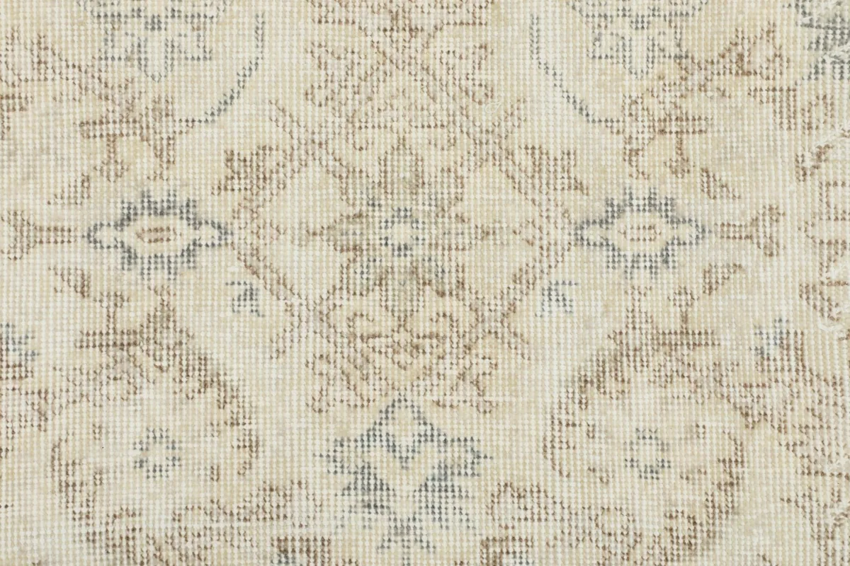 Close-up detail of the hand-knotted wool pile, showing the texture and subtle color shifts.