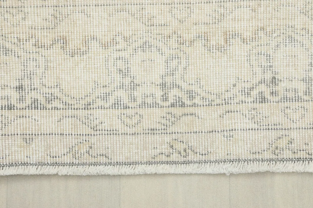 Detailed view of the rug's border design and fringe, showcasing the craftsmanship.
