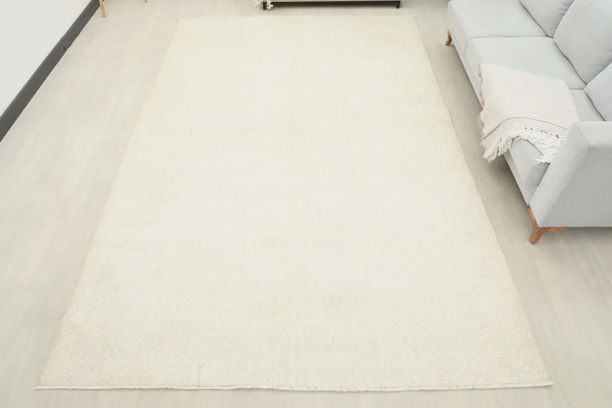 Full overhead view of the ivory vintage rug in a room setting, showcasing its large size and placement.