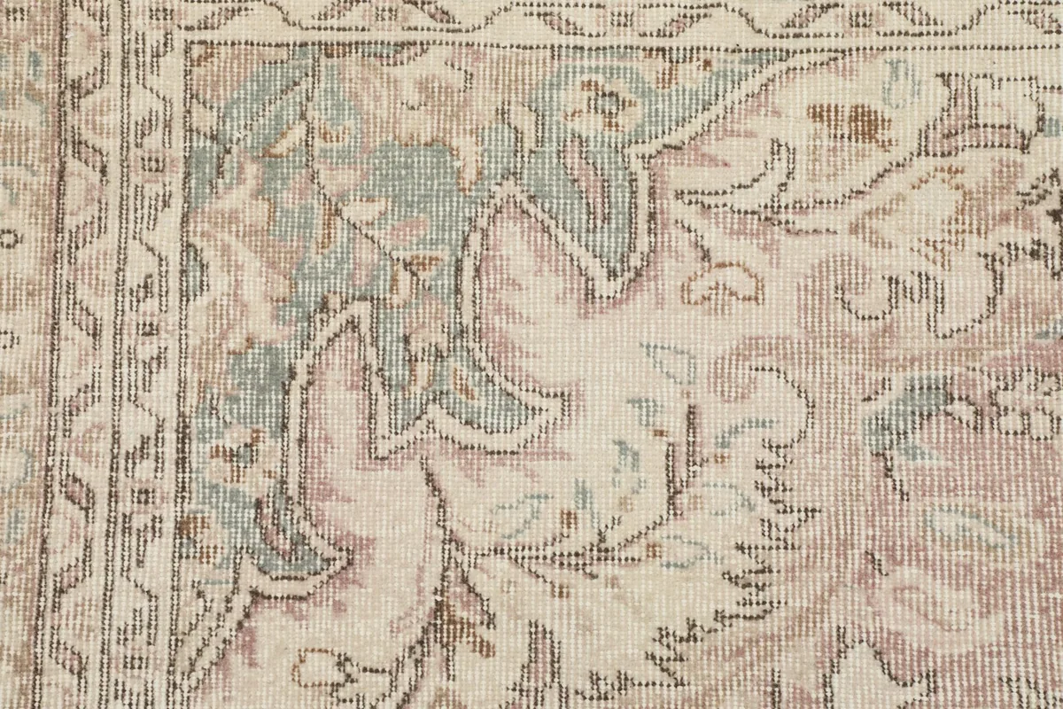 Detailed view of the intricate floral and geometric patterns in the rug