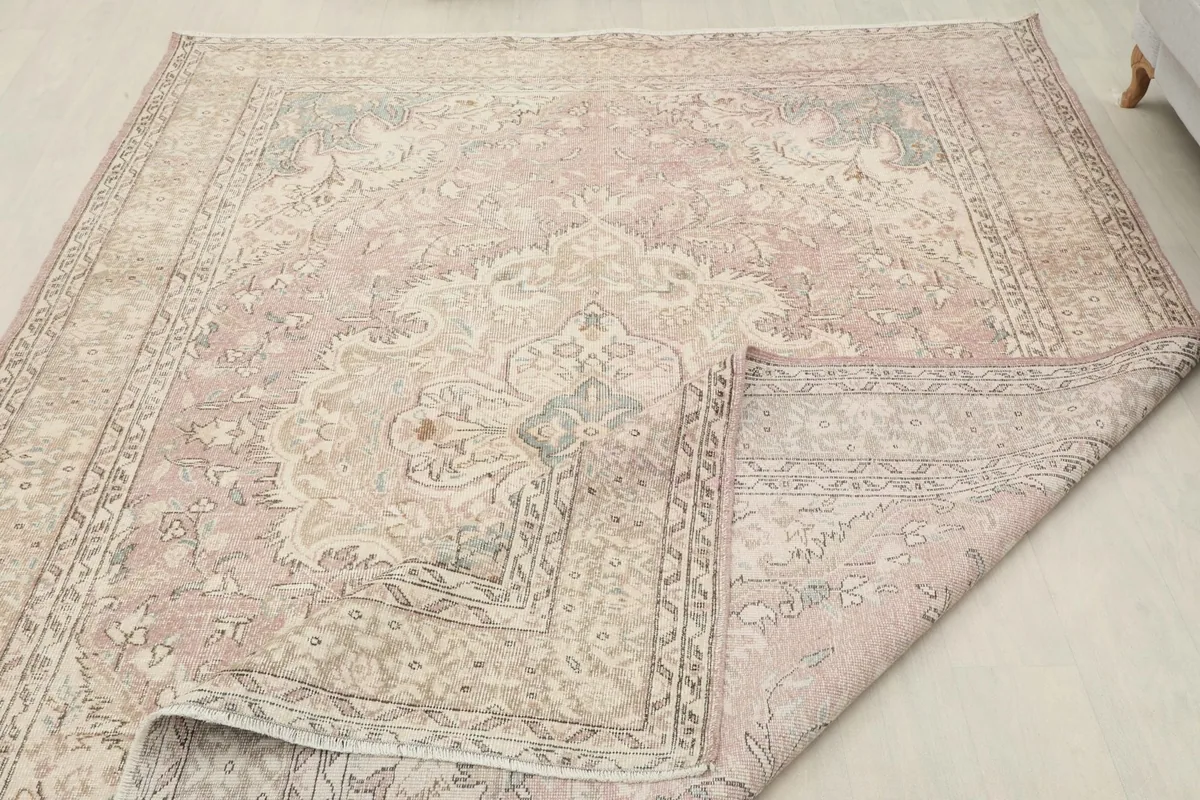 View of the rug with a corner folded back, showing the thickness and construction