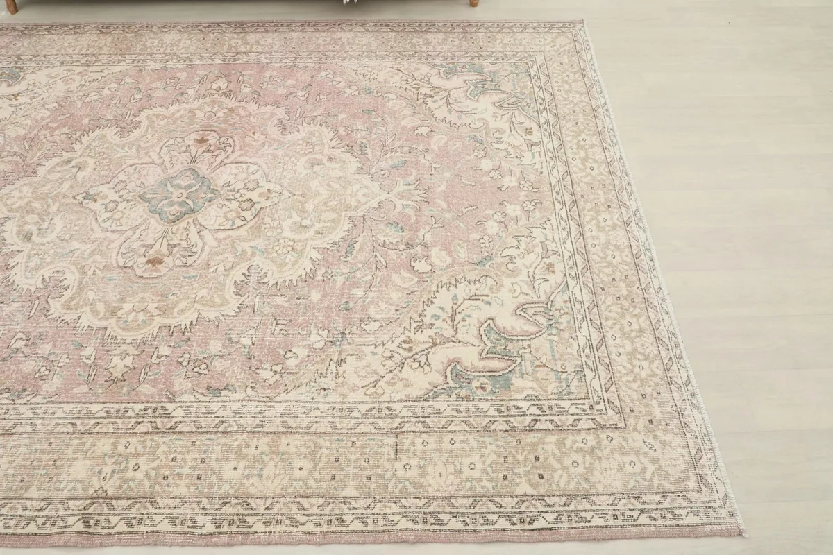 Overhead shot of the rose rug, highlighting the faded color and patterns