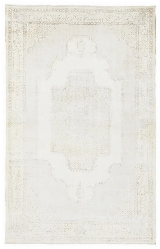Full top view of the 7x11 vintage Anatolian rug with an ivory field and faded tan medallion pattern