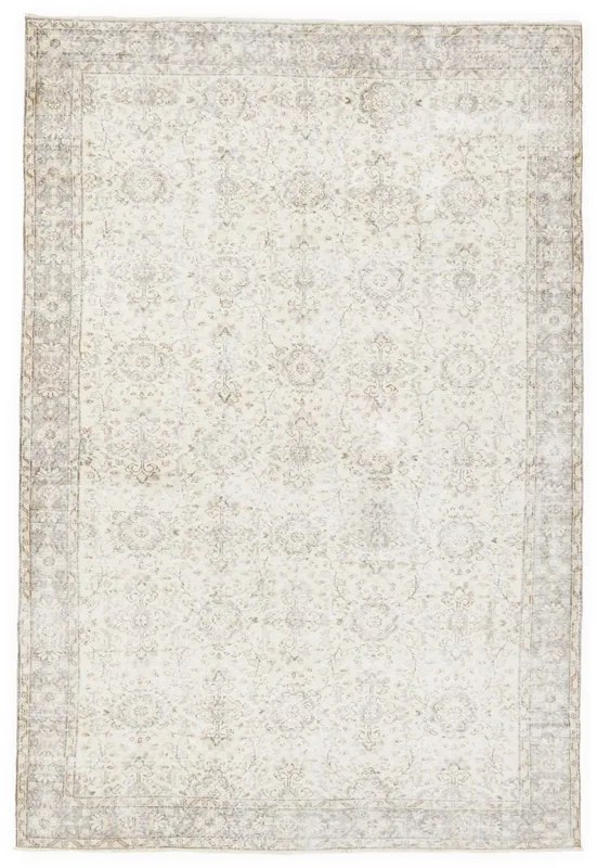 Full top view of the ivory and gray vintage Anatolian area rug with floral patterns.