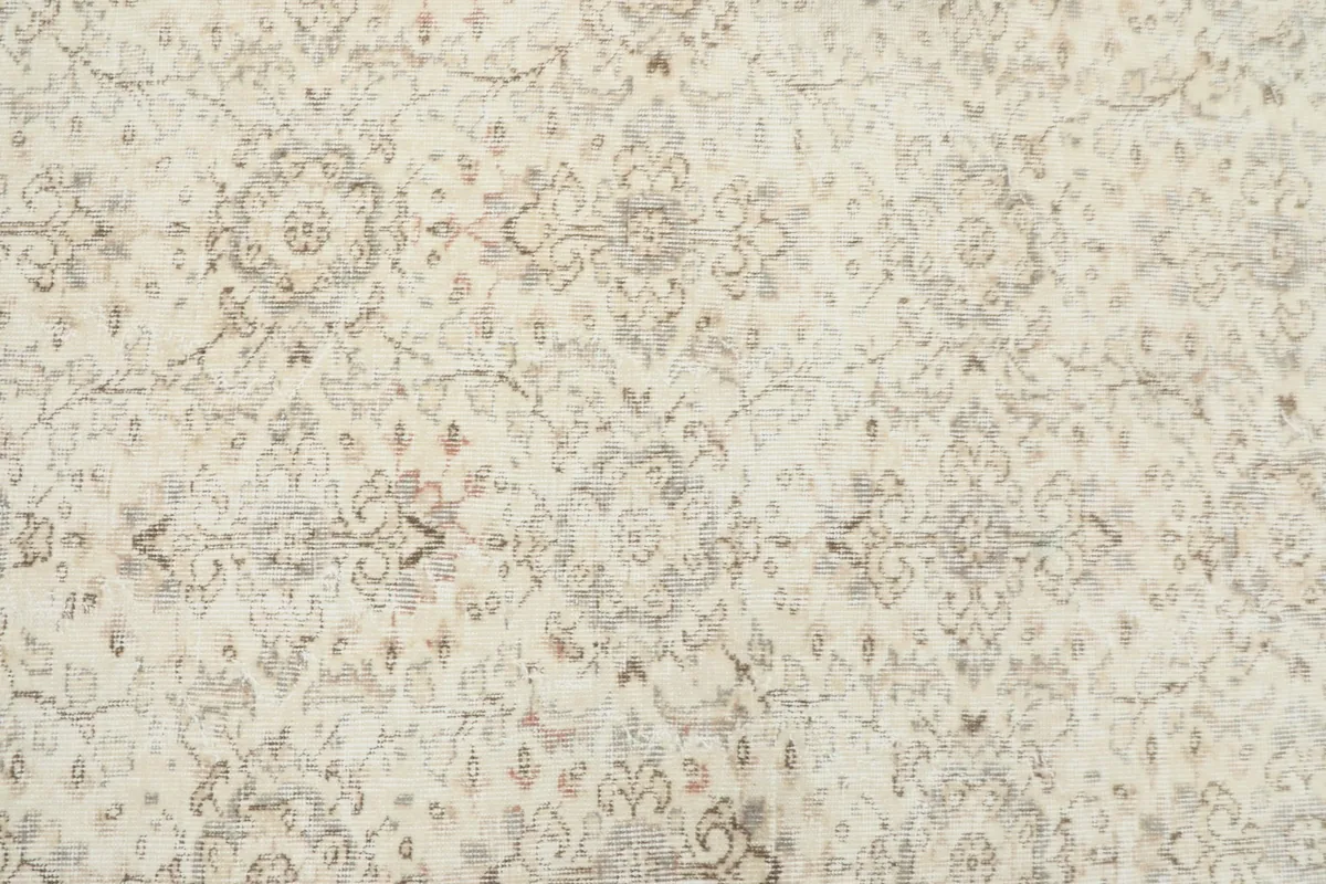 Close-up detail of the rug's central field, revealing the intricate floral and medallion designs.