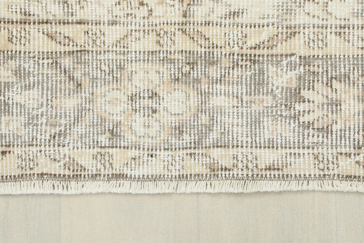 Close-up of the rug's border, showcasing the geometric patterns and fringe detail.