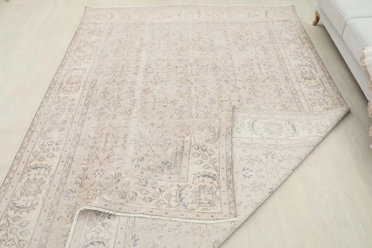 Rug with a corner folded back, displaying the reverse side and construction