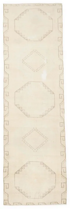Full top view of the 4x14 ivory and gray geometric Anatolian runner rug on a white background.
