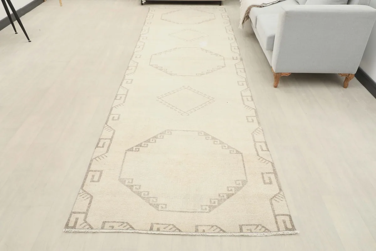 Full view of the ivory and gray runner rug extending along a modern living space.