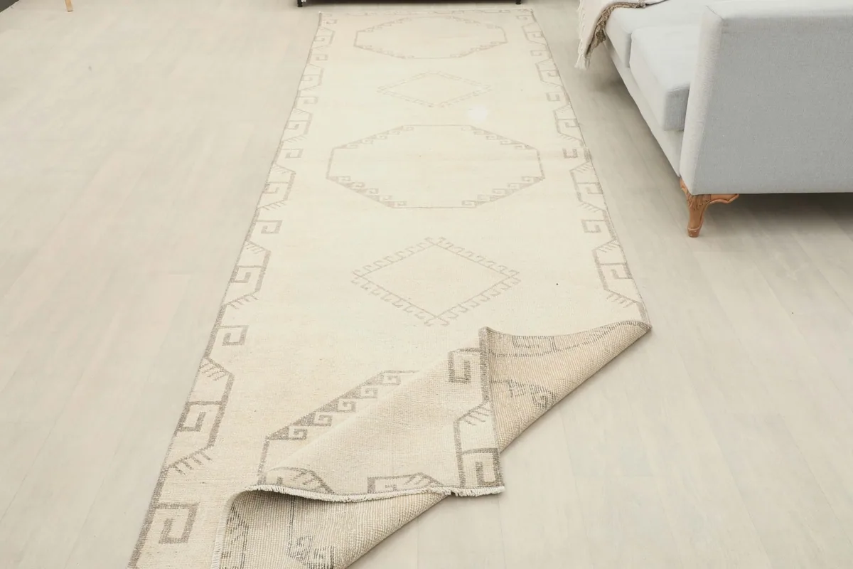 Runner rug with a corner folded over, showing the thickness and the back of the rug.