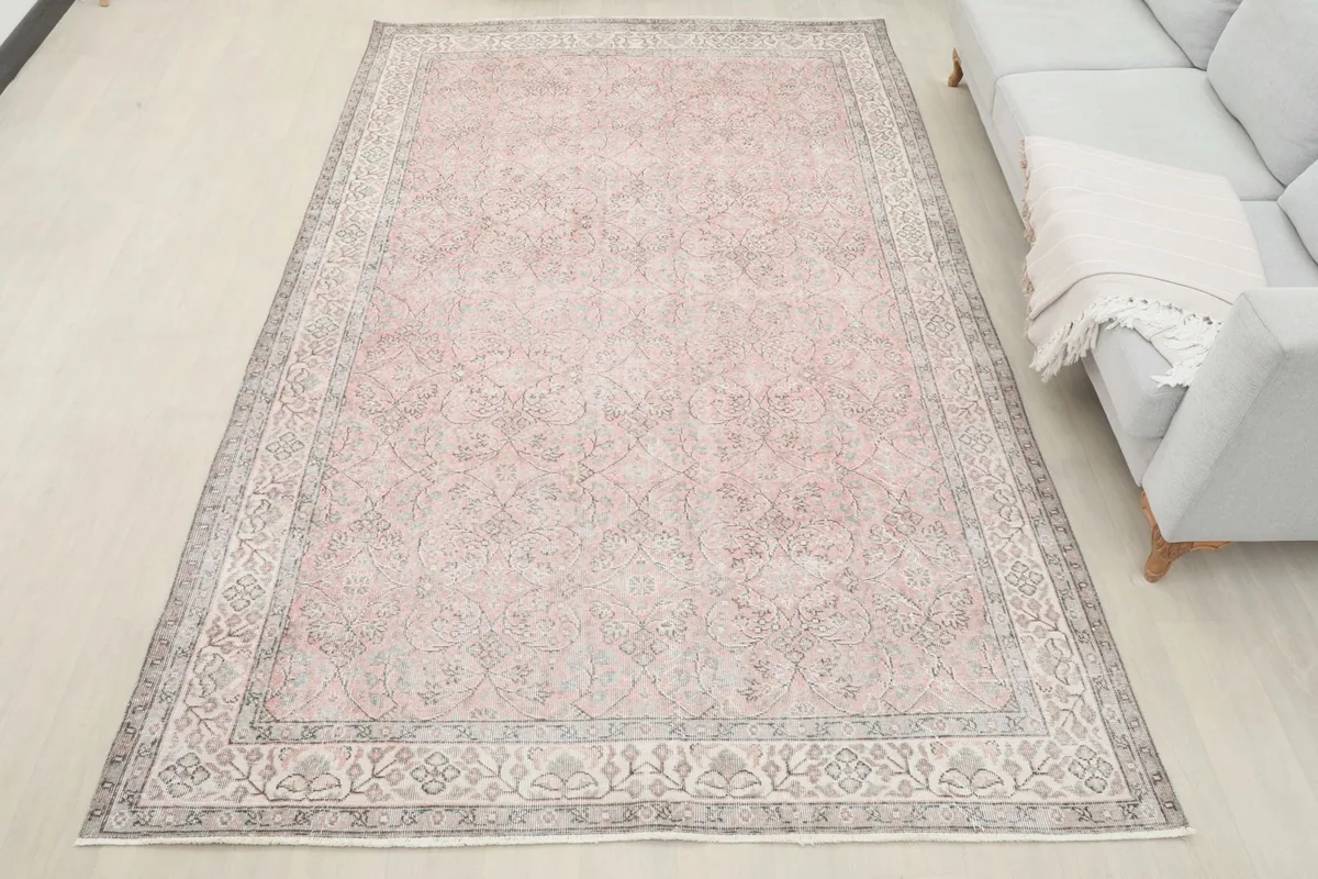 Overhead view of the 6x10 vintage rose and gray rug in a living room, showing its full scale.