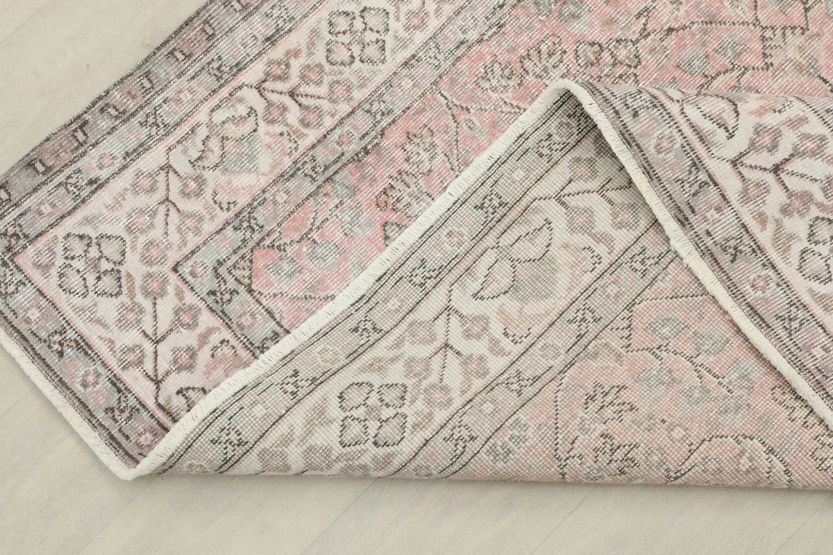 View of the back of the hand-knotted rug, revealing the cotton foundation and construction.