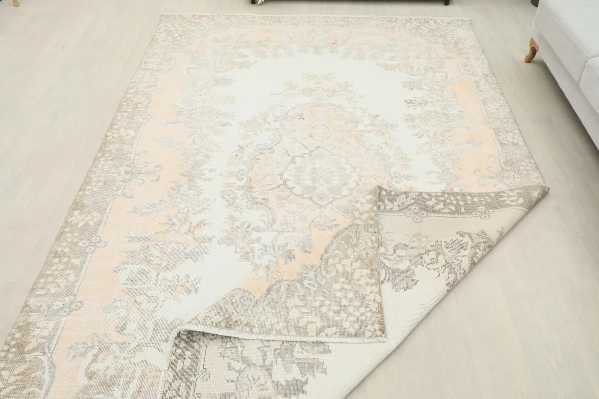 Rug with a corner folded back, showing the thickness and the back of the vintage Anatolian piece.