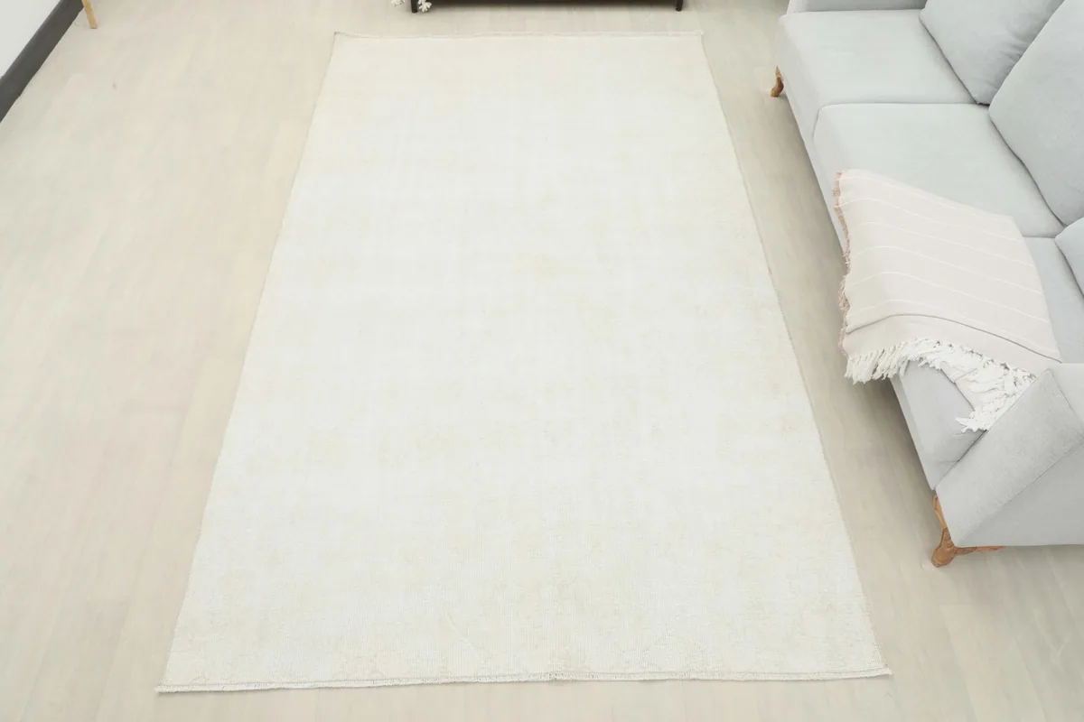 Full room view of the ivory vintage rug, providing a sense of its size and how it anchors the space.