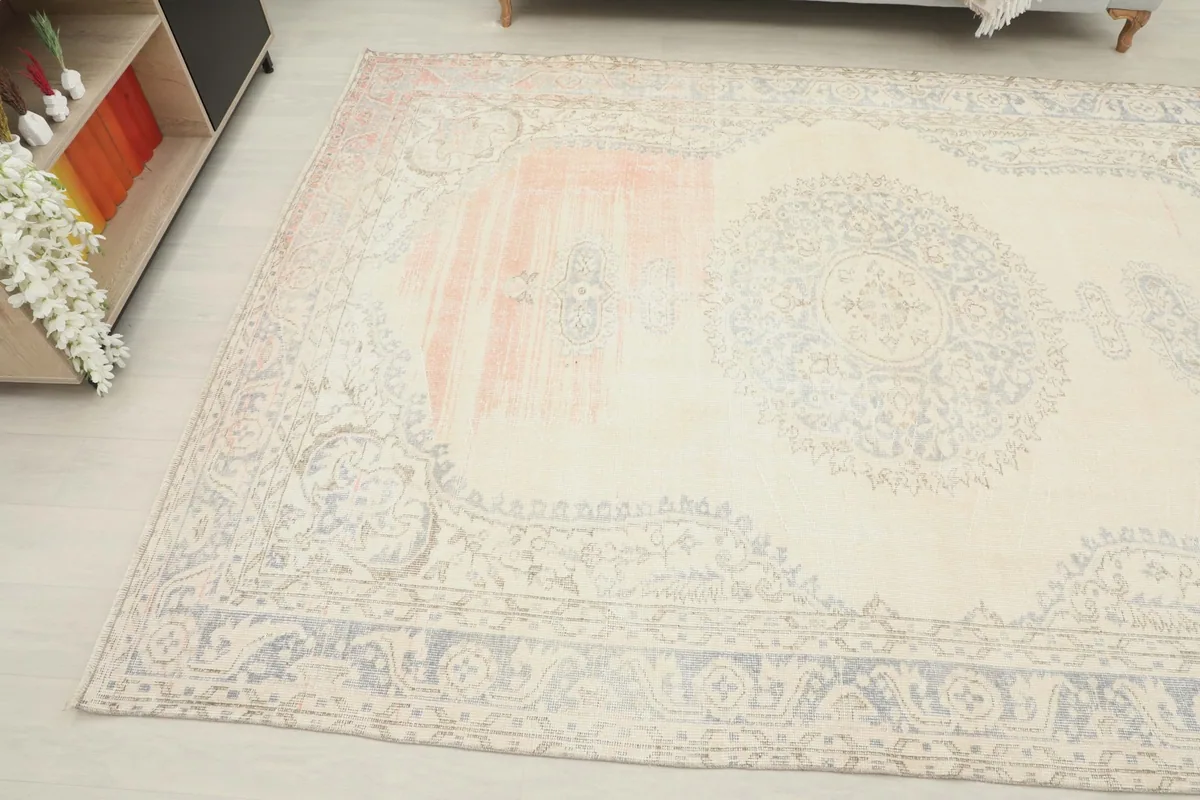 Overhead angle capturing the full length of the rug and its distinctive cream, gray, and rose colors