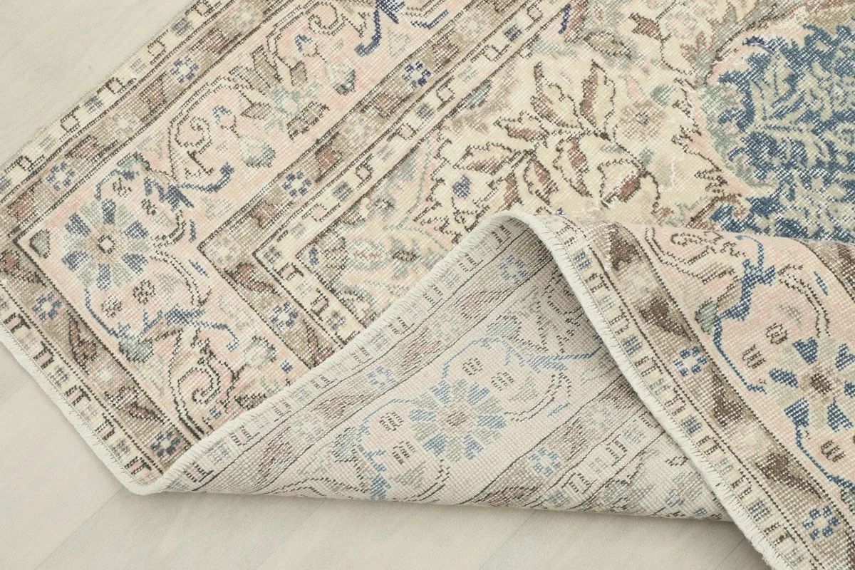 Corner of the runner folded back to reveal the cotton foundation and the reverse side of the hand-knotted construction.