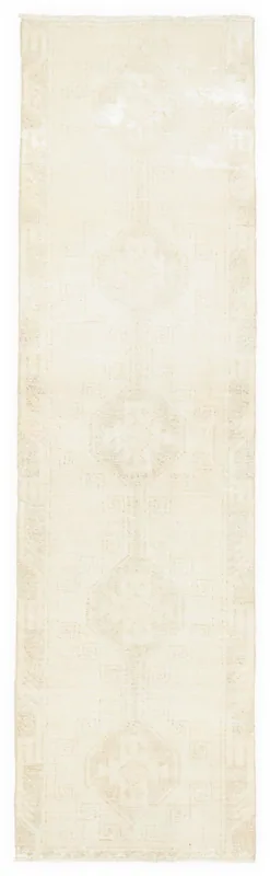 Full top view of the 3'4" x 12'3" ivory and beige geometric vintage Anatolian runner rug on a white background.