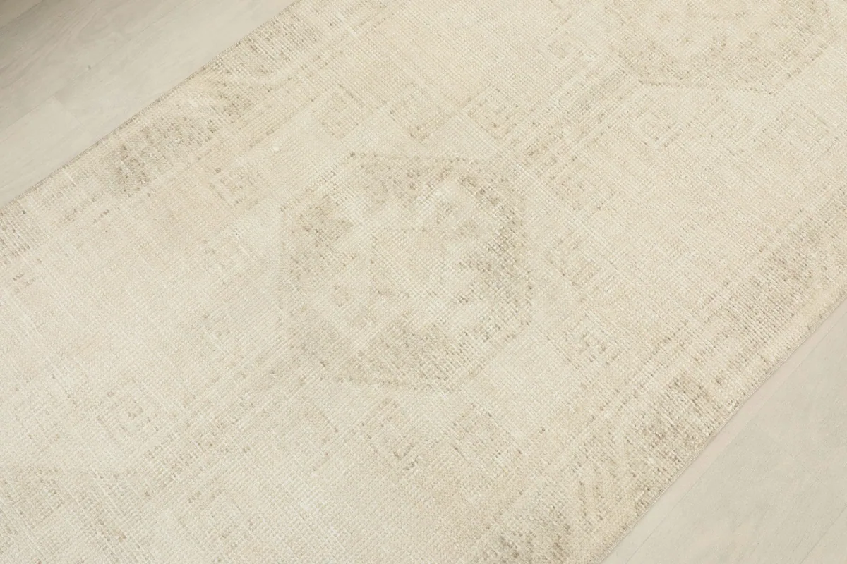 Close-up of a central geometric motif within the rug, showcasing the intricate weaving and tonal shifts.
