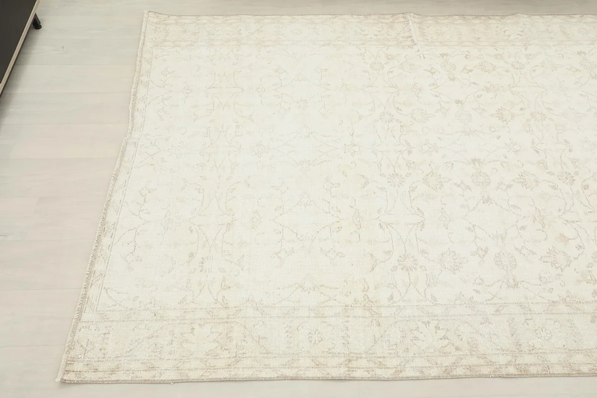 Another angled view of the ivory rug, showing its full length and the continuity of the pattern.