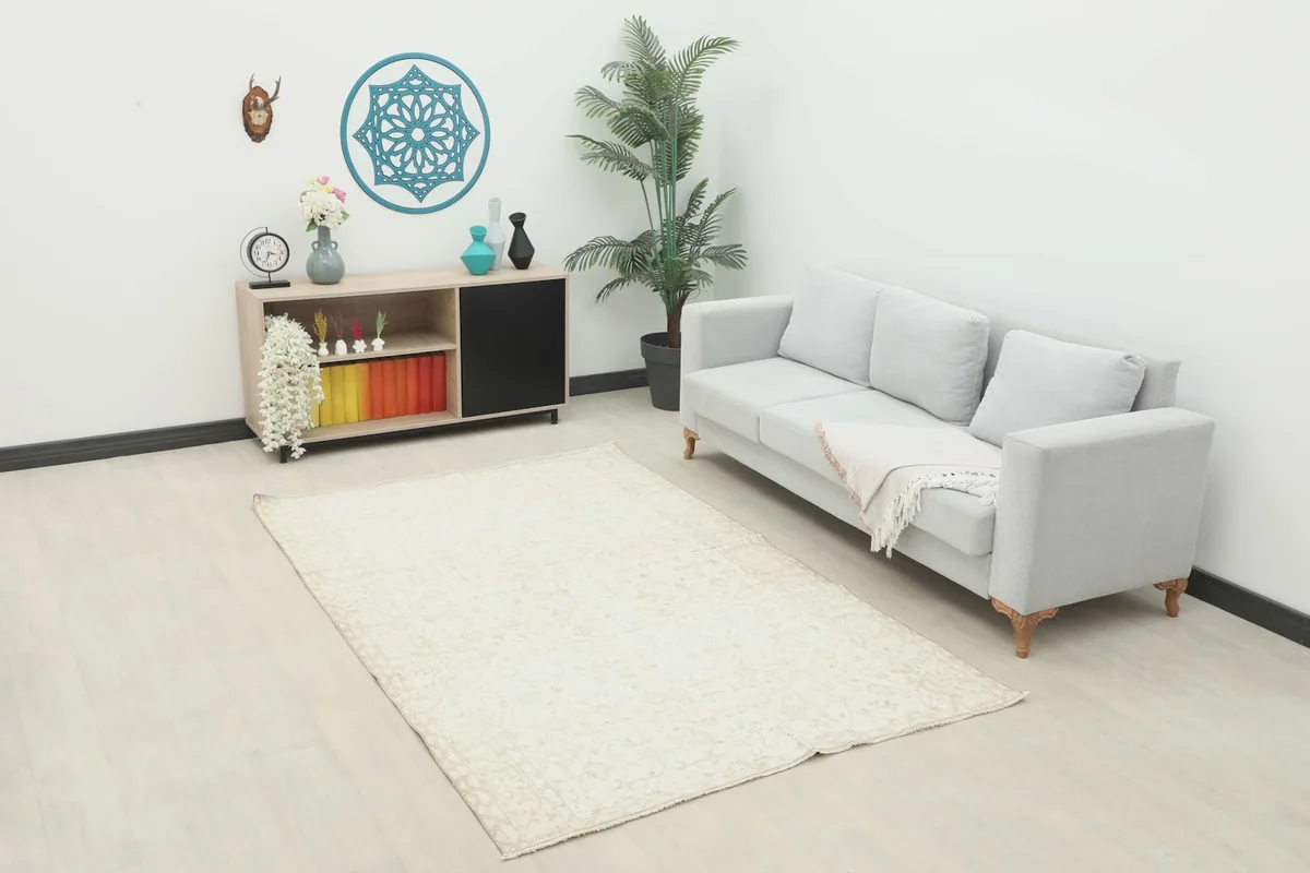 Ivory floral vintage rug in a modern living room setting with a light gray sofa.