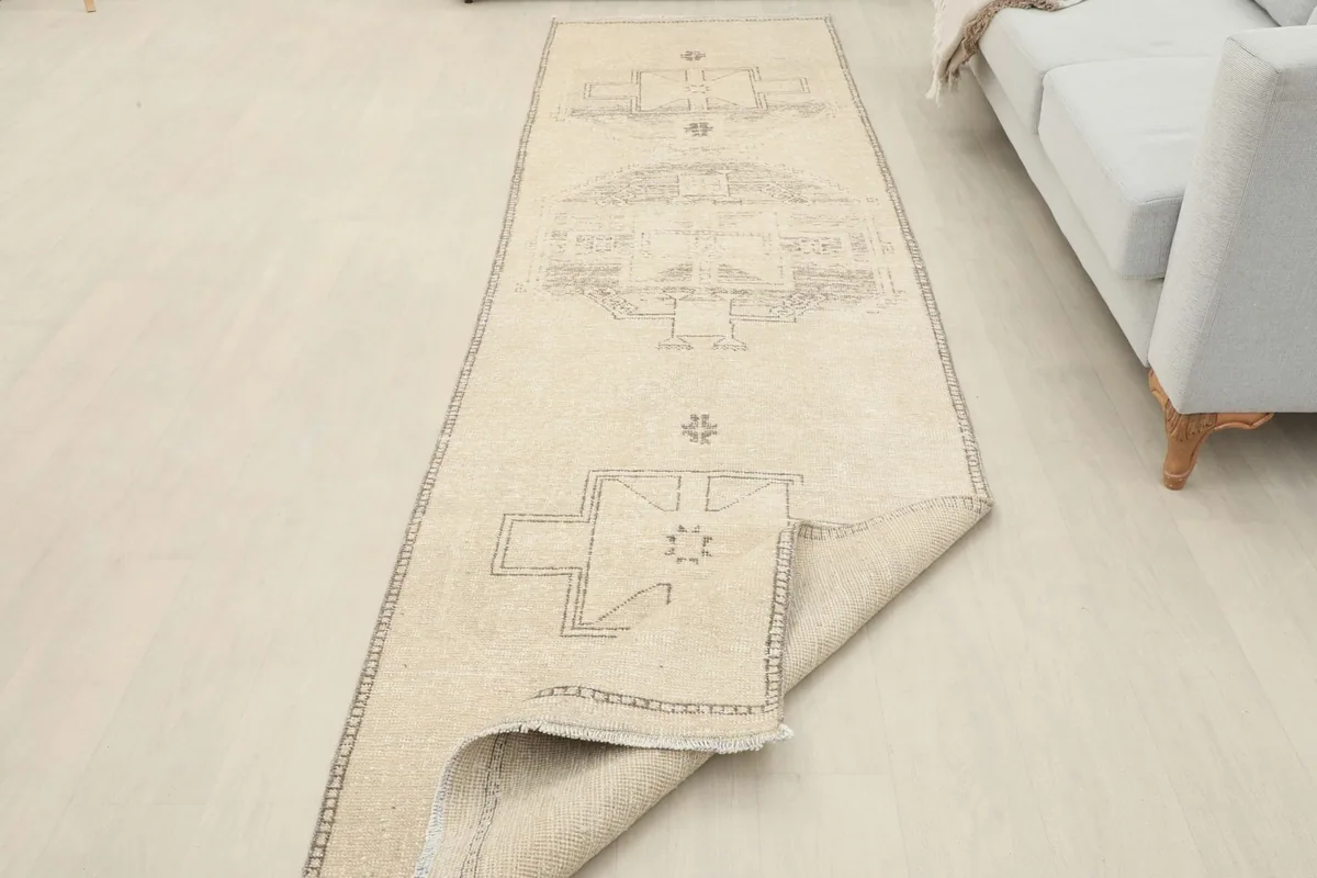 The runner partially folded, demonstrating its flexibility and the wool pile on cotton foundation.