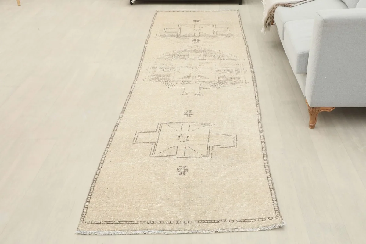 Full overhead view of the ivory runner rug laid out in a room, showcasing its entire length and design.